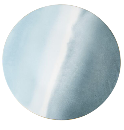 The Marie Daâge Tie Dye Platinum Dinnerware by Marie Daâge features a round ceramic plate with a smooth, pastel blue and white gradient pattern reminiscent of a watercolor wash, showcasing a minimalistic and modern design.