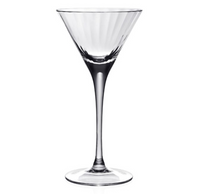 The Corinne Drinkware by William Yeoward features a clear martini glass with a wide conical bowl, long stem, and round base, reflecting modern barware style against a plain white background.