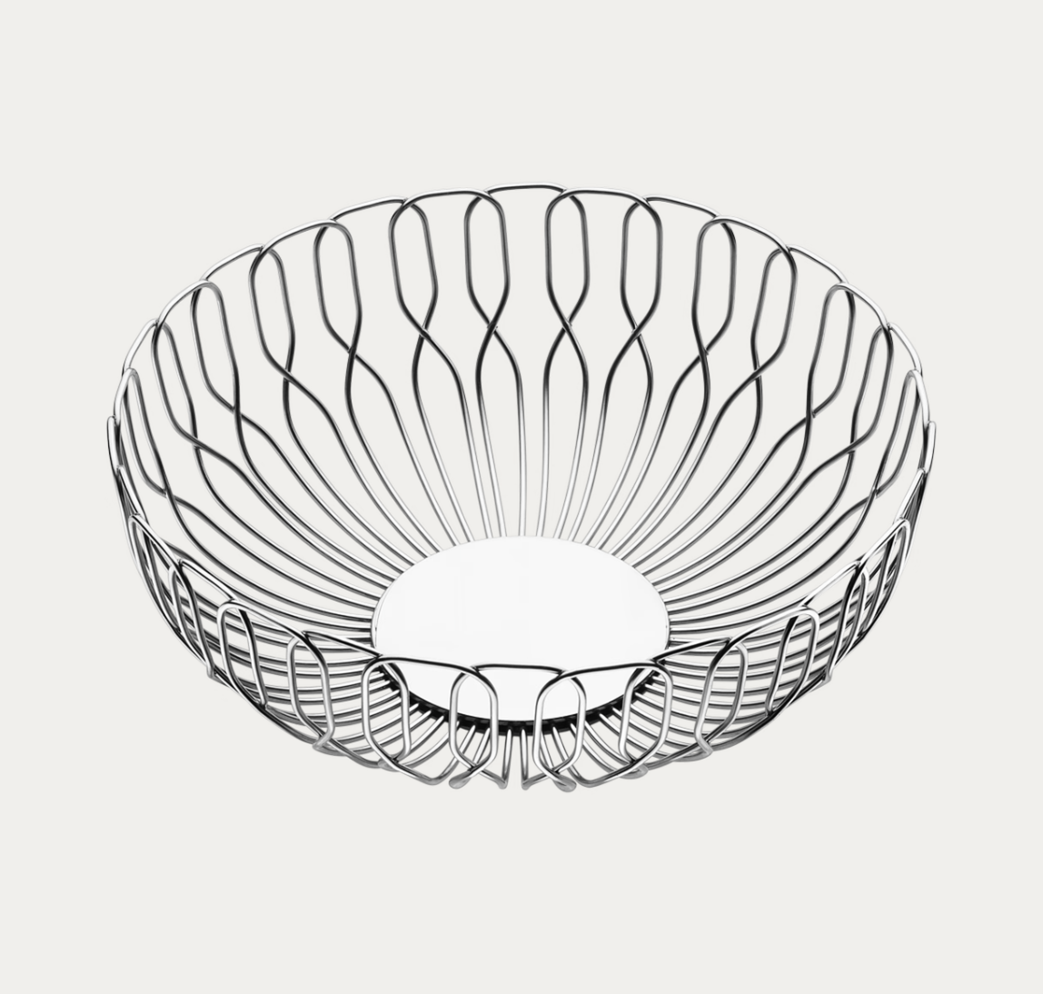 The Alfredo Bread Basket - Small by Georg Jensen is a round, open wire basket with a curved, sculptural design and a flat base, crafted from shiny stainless steel. Shown against a plain white background, this stylish piece is perfect for serving bread or fruit and adds a modern touch to any table setting.
