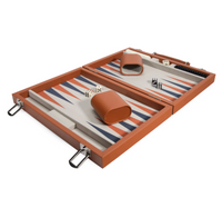 The Brouk & Co Mini Travel Backgammon Set features an orange case that opens to a playing board with blue, orange, and white triangles, plus magnetic checkers, dice, and two orange cups—ideal for games on the go.