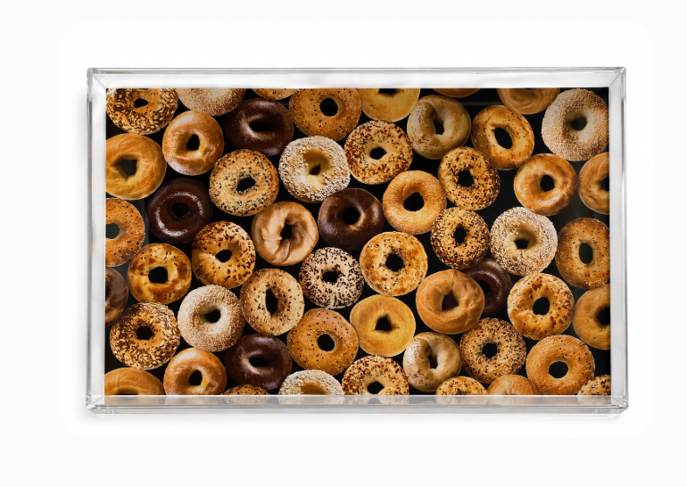 Top-down view of the Eye Candy Bagel Tray Wide - Bagel Print, filled with an assortment of bagels—plain, sesame, and everything varieties—neatly arranged and ideal for a holiday breakfast or festive brunch spread.