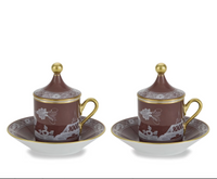 Two Ginori 1735 Oriente Italiano Castagna lidded espresso cups and matching saucers in brown with white floral patterns and gold rims and finials.