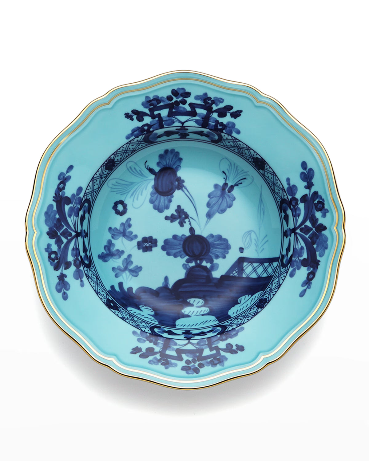 A blue porcelain bowl from the Ginori 1735 Oriente Italiano Dinnerware Iris collection, featuring scalloped edges, gold trim, and intricate dark blue chinoiserie floral motifs in the center and around the rim, reminiscent of classic Italian porcelain craftsmanship.