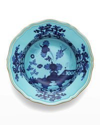 A blue porcelain bowl from the Ginori 1735 Oriente Italiano Dinnerware Iris collection, featuring scalloped edges, gold trim, and intricate dark blue chinoiserie floral motifs in the center and around the rim, reminiscent of classic Italian porcelain craftsmanship.