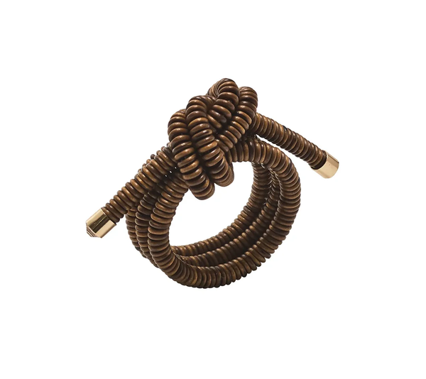 The Coil Napkin Ring Brown by Kim Seybert, featuring a coiled rope-inspired design in brown with gold metal tips and a central knot, is shown on a white background. This product comes as a set of 4.