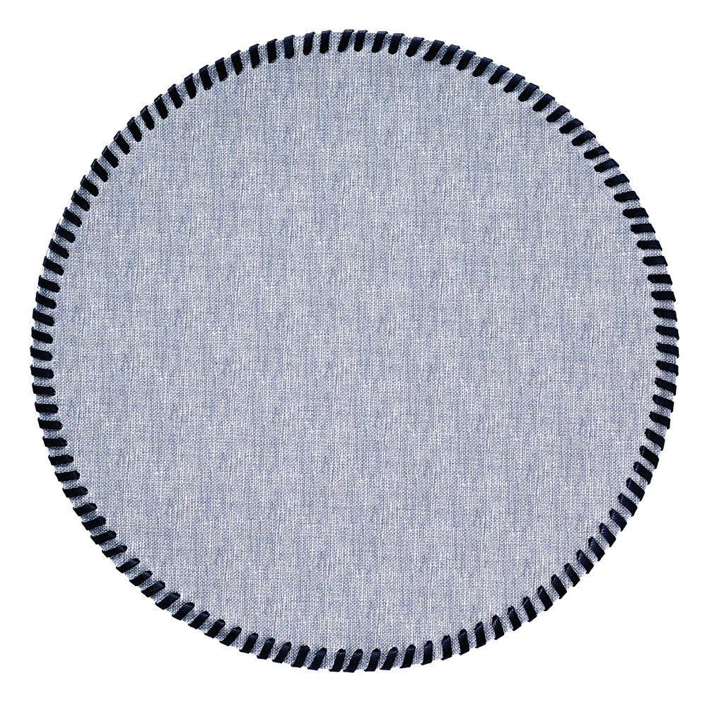 A round, light blue Bodrum Whipstich Round Placemat with a dark blue whipstitch edge.