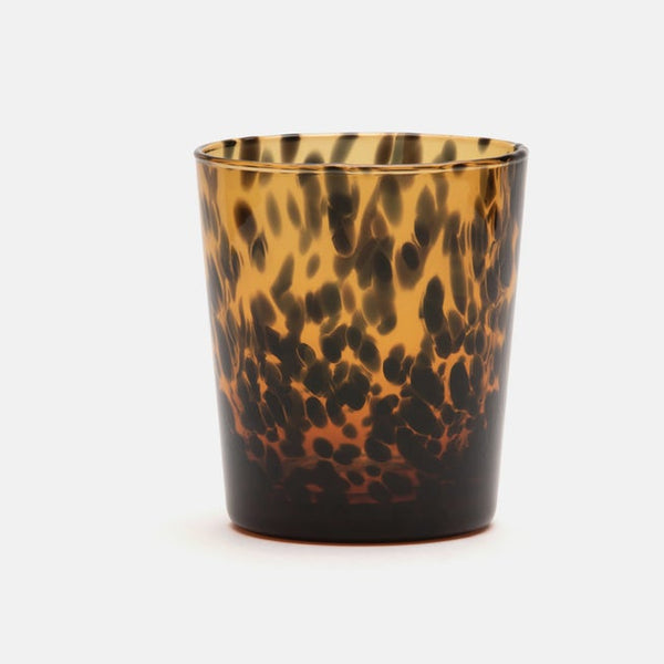 The Blue Pheasant Andrew Drinkware DOF - Tortoise is a hand-blown glass tumbler with a brown and amber tortoise shell pattern, featuring spots and a translucent finish, set against a plain white background.