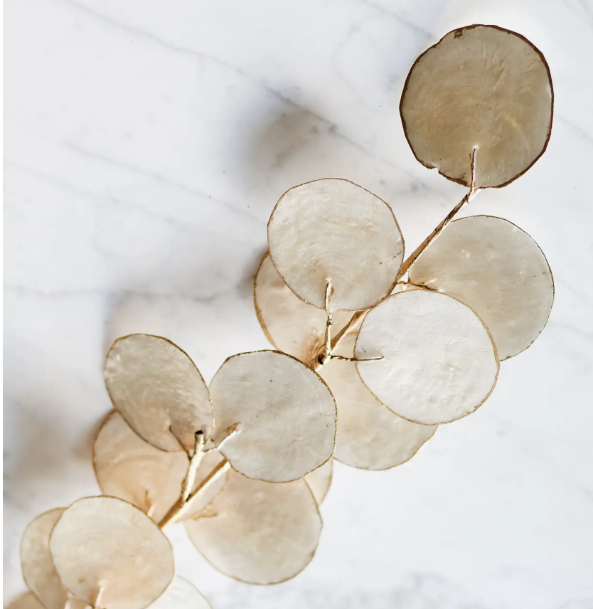 Dekorasyon Capiz Leaf Stem featuring translucent, circular leaves resting on a white marble surface, ideal for Thanksgiving table decor.