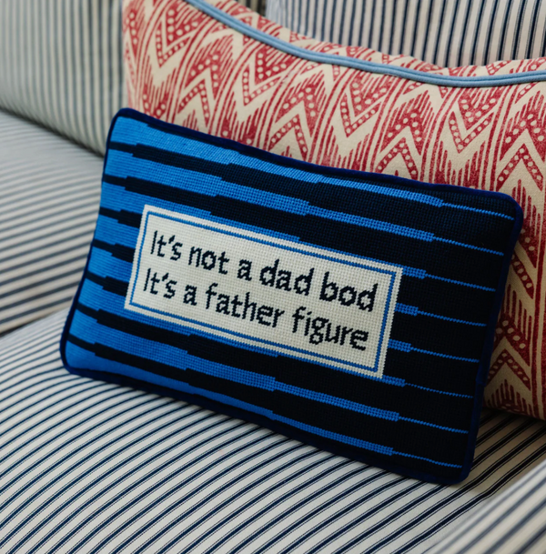 Decorative pillow with text on a striped couch