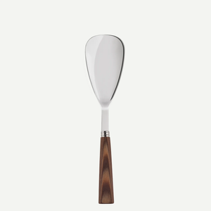 The Sabre Nature Rice Spoon features a wide, flat stainless steel blade and a dark wooden handle, shown against a white background—perfect for pairing with matching flatware for a cohesive kitchen aesthetic.
