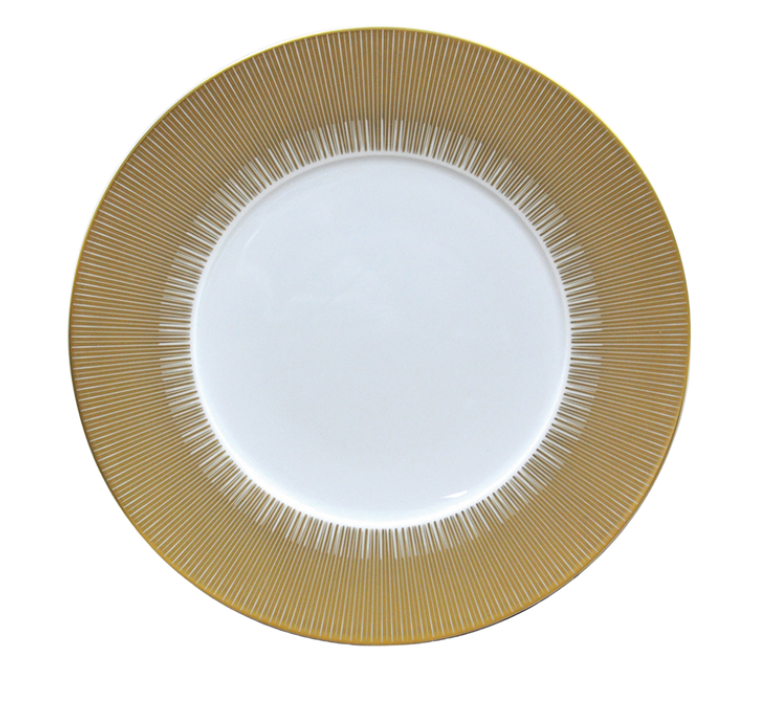 The Sol Dinnerware plate by Bernardaud features glossy white Limoges porcelain with a wide 24k gold rim adorned in a radiating line pattern, giving this elegant piece its signature decorative appeal.