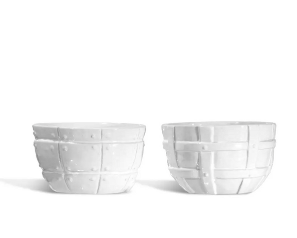 Two white ceramic bowls from Montes Doggett’s Serveware Set of 2 – Bowl 987, featuring raised grid and geometric patterns, are displayed side by side on a white background. These high-fired pieces are thoughtfully designed for everyday use, seamlessly blending durability with elegant craftsmanship.
