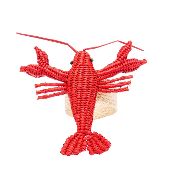 The Coro Cora Lobster Napkin Ring Set of 4 features pink, lobster-shaped woven napkin rings atop light-colored baskets, celebrating Colombian craftsmanship against a white background.