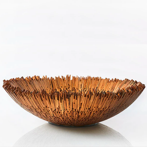 The Boracay Centerpiece Bowl by Quilted Koala is a handcrafted decorative piece made from reclaimed mahogany, featuring a round design with bold, vertical spikes along the edge that create a striking, textured silhouette. Its natural brown hue adds warmth and character, making this Philippines-made bowl an eye-catching centerpiece—especially when set against a white background.