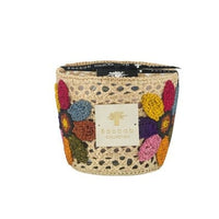 A decorative beige crochet basket with colorful crochet flowers and a Baobab label—an elegant home décor piece, perfect for displaying your favorite Baobab Tournesol Girasol Candle or any artisanal candle.