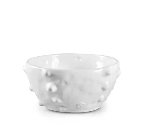 The Montes Doggett Ceramic Serveware - Bowl 130 is a handmade white ceramic bowl with a glossy finish and distinctive raised, irregular bumps on its surface, set against a plain white background. This high-fired bowl is microwave safe and beautifully highlights the unique character of artisan ceramics.