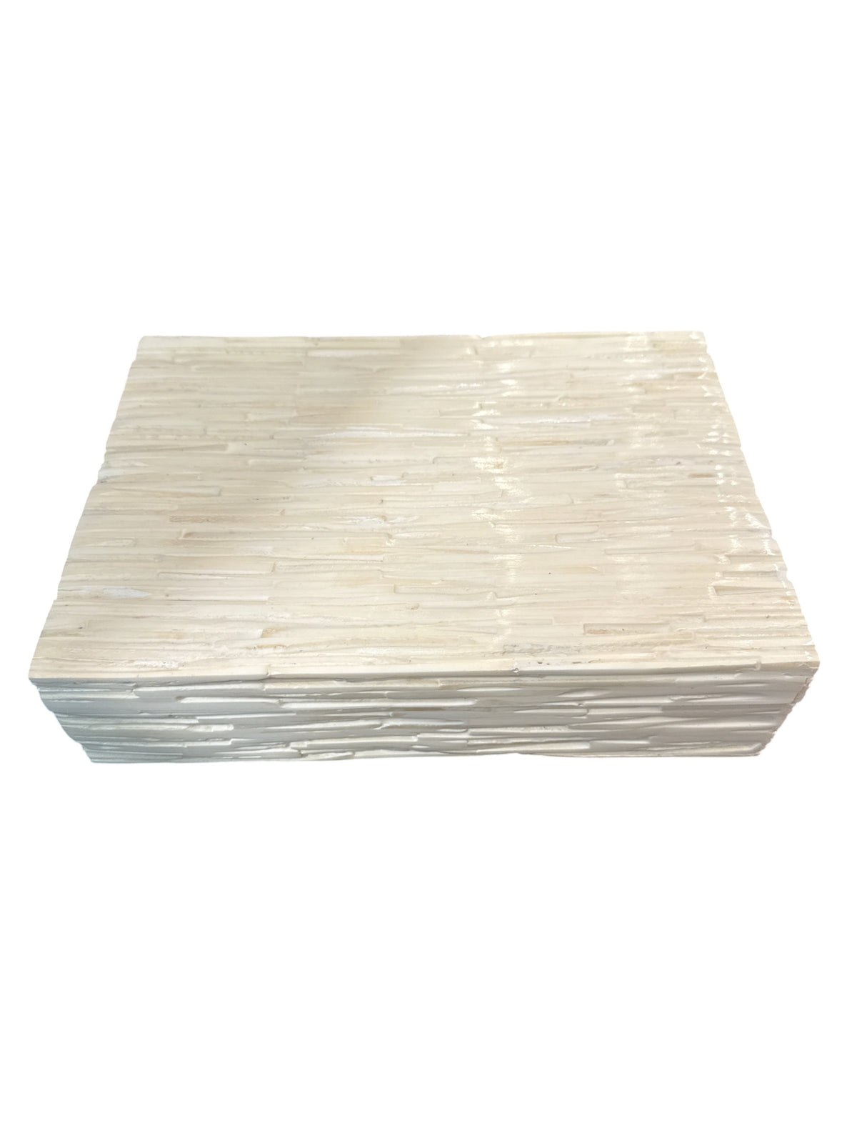 A Sanoma Inc’s Bone Tiles Box in ivory (medium) features a rectangular, flat design with a textured off-white surface and horizontal ridges reminiscent of layered stone or wood, shown against a white background.