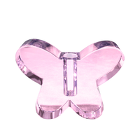The Crystal Butterfly Bud Vase - Pink by Tizo stands upright on a white background, its transparent light pink acrylic form delicately shaped to evoke a fluttering butterfly.