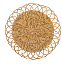 The Alfresco Placemat Set of 4 by Kim Seybert features round, handwoven placemats with an intricate pattern and scalloped edges in natural light brown—ideal for outdoor dining.