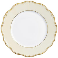 The Raynaud Mazurka Gold & Ivory plate features a scalloped edge, cream-colored border with gold trim, and a plain white center—a stunning example of French porcelain craftsmanship.