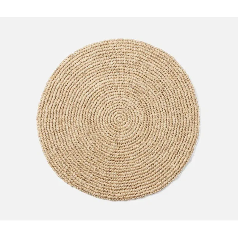Emmy Round Placemat S/4 - Natural, a round, coiled, woven fiber placemat.