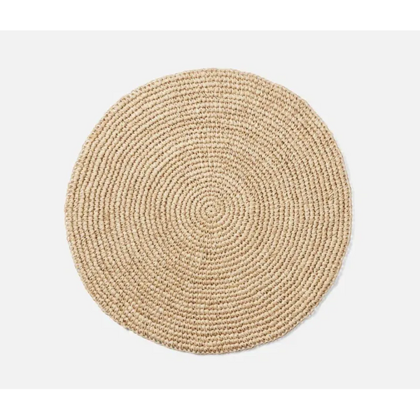 Emmy Round Placemat S/4 - Natural, a round, coiled, woven fiber placemat.