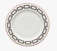 A Catene Nero Dinnerware plate by Ginori 1735, featuring white ceramic with a gold rim and a striking geometric black pattern around the edge, shown from above on a white background.