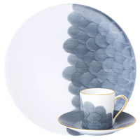 A large plate, small saucer, and teacup from the Marie Daâge Cercle D’Ecailles Gold Filet collection by Marie Daâge, featuring a matching blue scalloped pattern and gold trim, exquisitely crafted from Limoges porcelain and displayed against a white background.