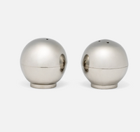 Two spherical, metallic Helios Salt & Pepper Shaker Set pieces with small holes on top.