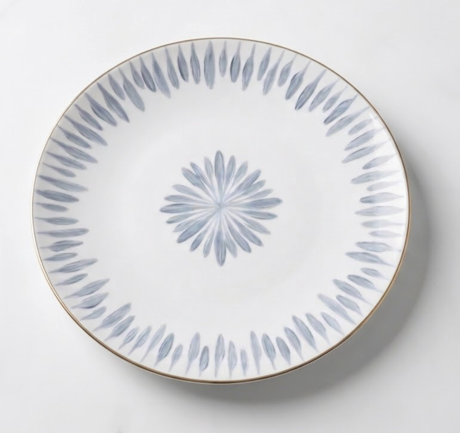 The Marie Daâge Allee de Cypres 4 plate by Marie Daâge is a white ceramic piece with a thin gold rim and blue-gray leaf motifs, showcasing luxury tableware and timeless hand painted dinnerware artistry.