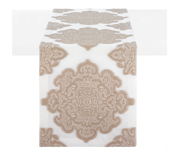 The Castille Table Runner 90″ - Sand by Bodrum features an intricate beige medallion pattern on a white background, elegantly draped over the center of a white table. Part of the refined Castille table linens collection, it is an ideal choice for sophisticated table decor.