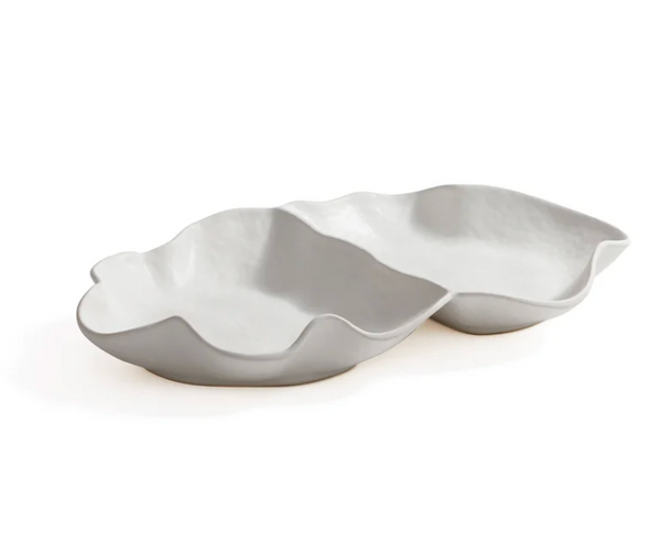The Zodax Alto Two Section Ceramic Serving Bowl features a modern, sculptural matte white design with two connected, irregular compartments, resembling abstract leaf or shell forms.