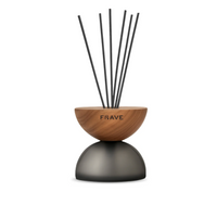 The Breath Wood Frosted Glass Diffuser – Elderflower by Frave Home features a wooden bowl, matte black rounded base, black reed sticks, and fills your space with a subtle elderflower scent and elegant touch.