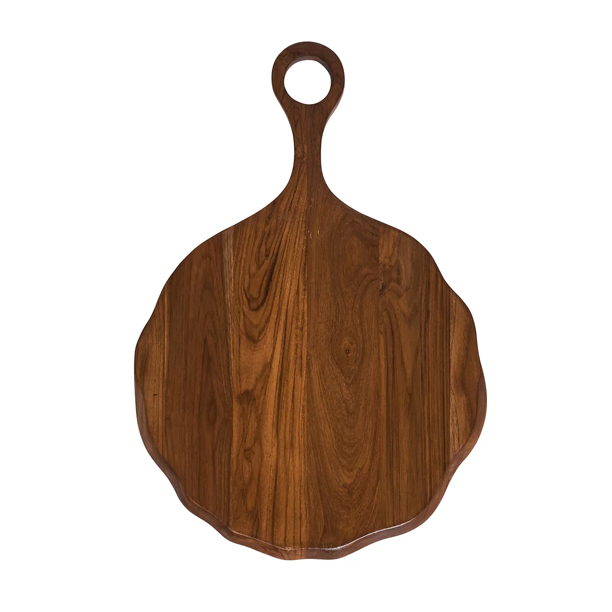 The Juliska Puro Round Serving Board Teak features hand-carved teak wood with a scalloped edge and a handle adorned with a circular hole; this elegant charcuterie board is beautifully showcased on a white background.
