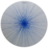 A set of four circular wooden placemats from Tisch New York, the Graphic Line Placemat set features the “Cobalt” design: bold blue lines radiate outward from the center across a white background, creating a dramatic starburst effect. Each placemat is crafted in the USA with a durable cork backing, combining artistic style with lasting functionality.
