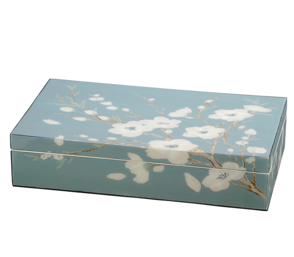 The Jamie Young Floral Lacquered Box is a rectangular blue decorative box with a hinged lid, featuring hand-painted florals and thin brown branches in an elegant white pattern.
