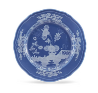 Ginori 1735 Oriente Italiano Indaco ceramic plate with a scalloped edge and a white landscape motif.