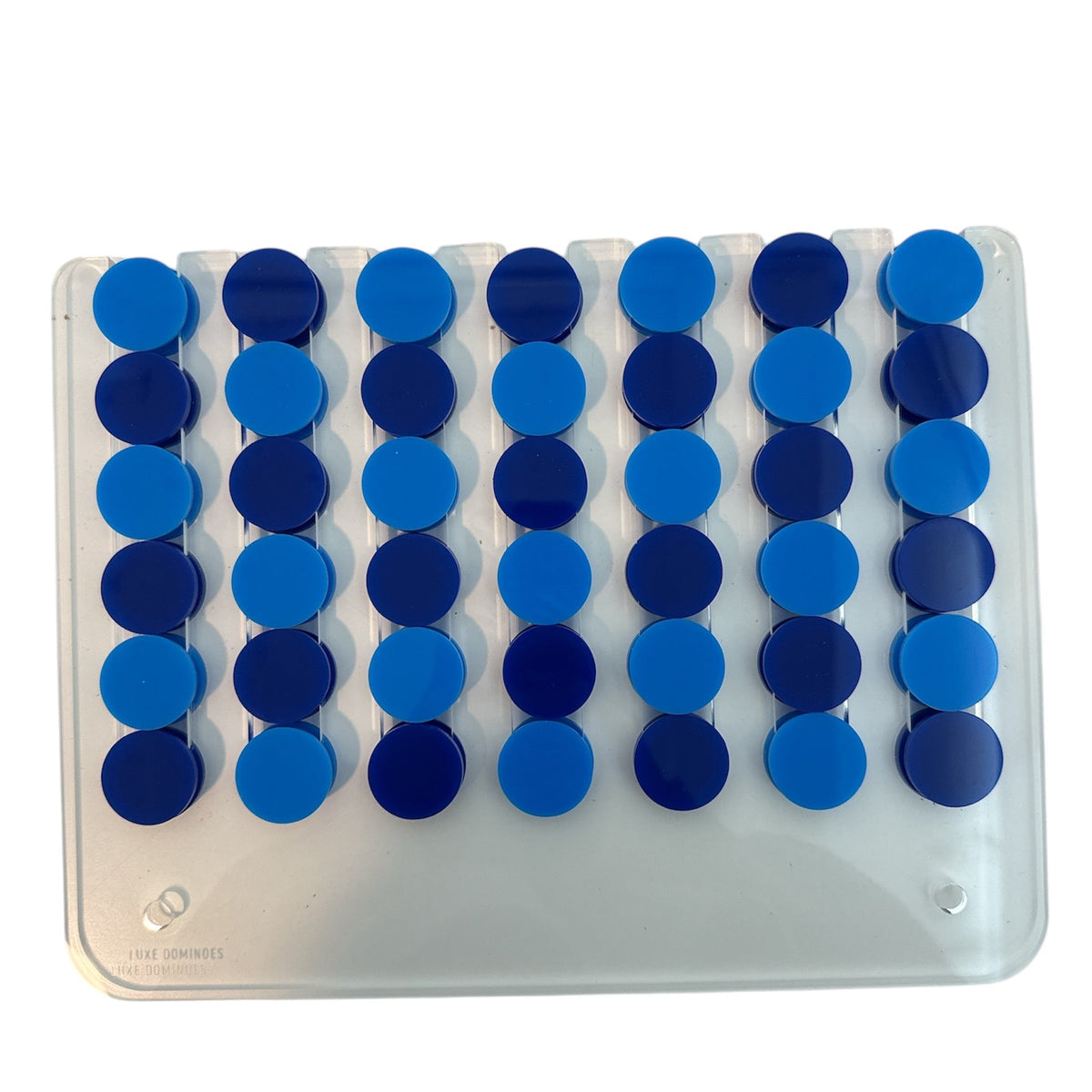 The Luxe Dominoes Connect Four El Cuatro features a clear plastic board with six columns filled with alternating light and dark blue round tokens arranged in rows, evoking the classic Connect Four game. The board is photographed from above against a white background.