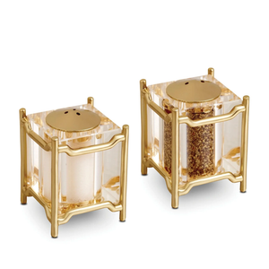 The Han Spice Jewels Set Salt & Pepper by L'Objet features elegant square shakers with clear bodies and 24k gold-plated frames and lids, presented in a luxury gift box—ideal for gifting.