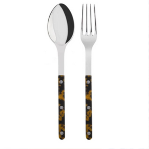 The Sabre Bistrot Shiny Solid Serving Set features a metal spoon and fork with dark handles in a yellow and brown tortoiseshell pattern, accented by three rivets, exuding Parisian flair against a white background.