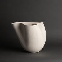 The Carmen Vase by FlowDecor Inc. features a matte white finish, abstract silhouette, rounded base, and flowing organic shape.
