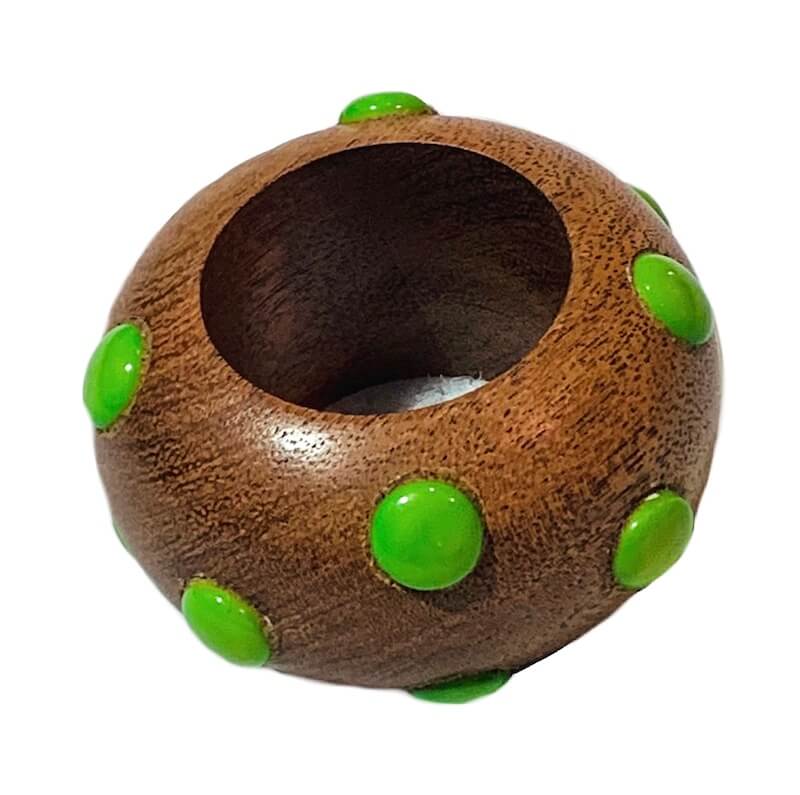 Part of the Candy Dots Napkin Ring Set of 4 by Von Gern Home, this round brown wooden napkin ring features raised bright green dots and a smooth finish, adding a playful pop of color to your tabletop.