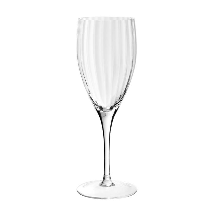Standing upright against a white background, the Corinne Drinkware - Goblet by William Yeoward is a clear, handmade crystal glass with a long stem and a slightly curved bowl. Elegant subtle vertical ridges along the surface bring Jazz Age-inspired sophistication to this refined piece of drinkware.