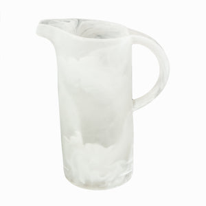 The Nashi Home Swirl Resin Classic Pitcher is a tall, translucent white pitcher with a marbled swirl pattern, curved spout, and rounded handle. It's shatterproof, dishwasher safe, and shown against a plain white background.