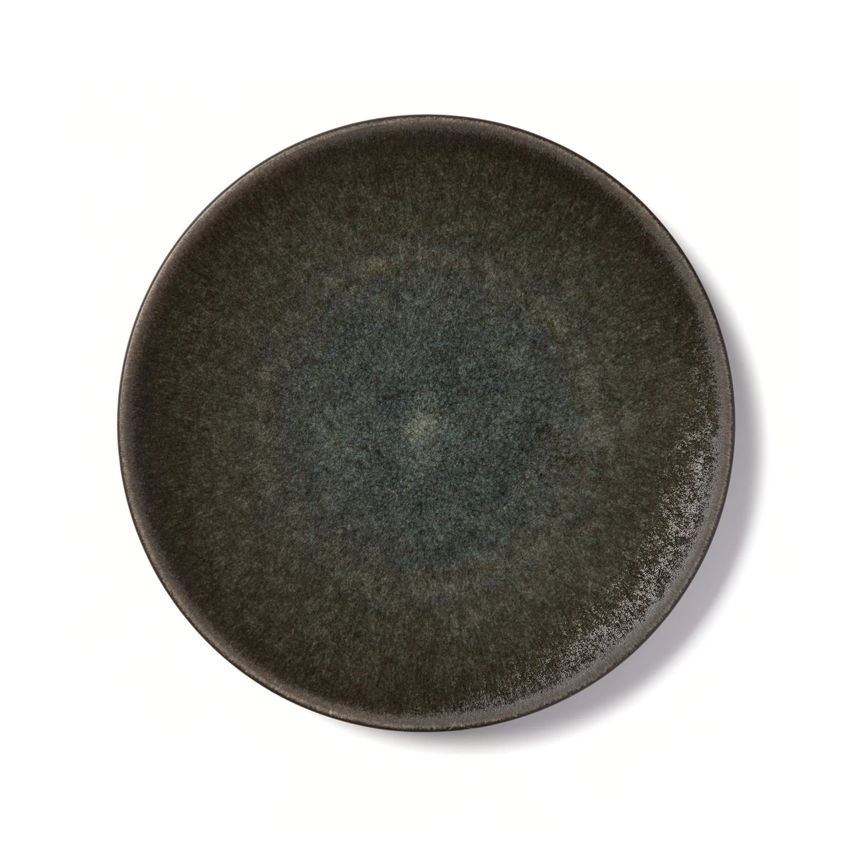 The Tourron Samoa round artisan stoneware plate by Jars - Rosenthal, featuring dark gray speckles, casts a subtle shadow against a white background.