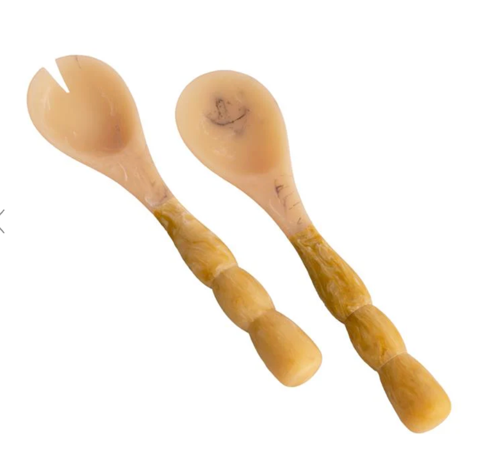 pair of resin salad servers on white backgroun d