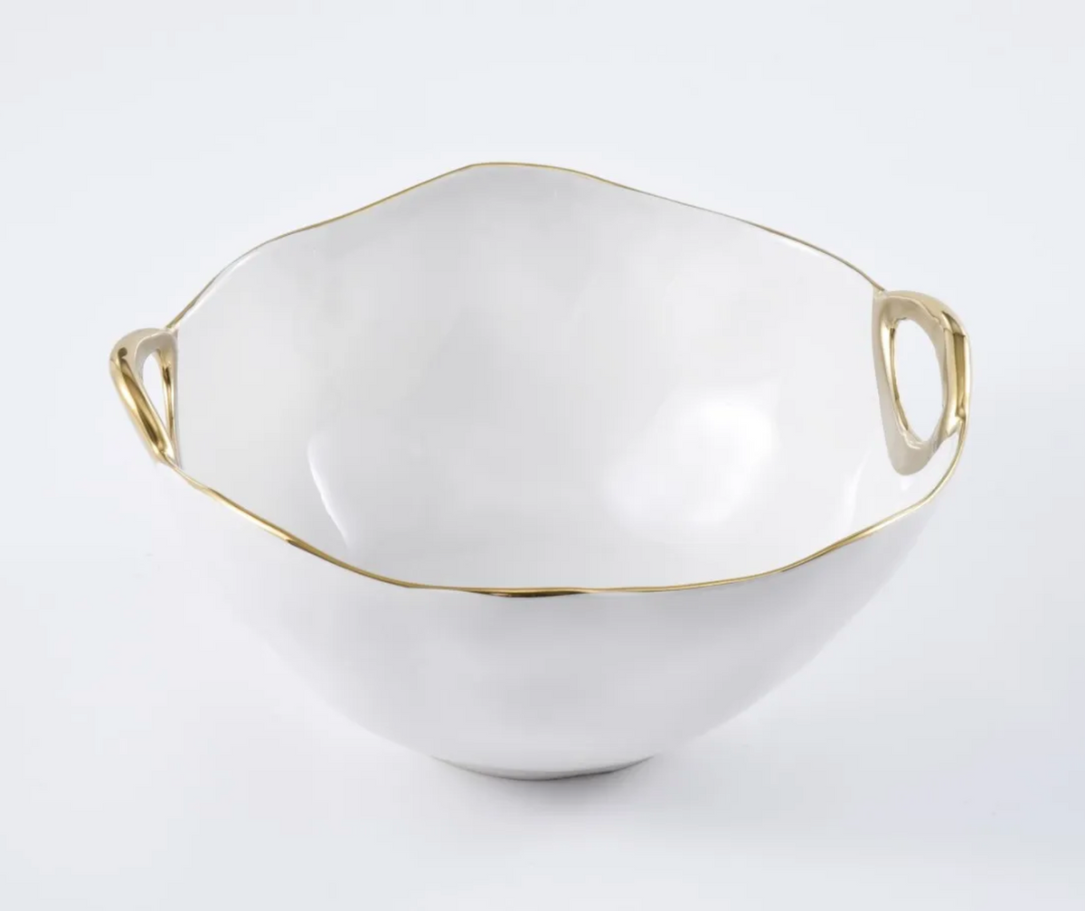 Introducing the PAMPA BAY Golden Handle Bowl—a high-fired, white porcelain bowl distinguished by its irregular, wavy rim and accented with two small gold handles. A slender gold trim along the rim enhances its elegance, making it a stunning piece of serveware. This beautiful bowl is showcased against a plain white background.