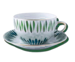 The Marie Daâge Allee de Cypres 5 teacup and saucer by Marie Daâge features hand-painted green and blue leaf patterns with gold accents, offering a luxurious porcelain tableware piece.