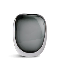 The Paul Vase by FlowDecor Inc. features smooth, rounded smokey grey glass and sits elegantly on a white background—an ideal accent for modern home décor.