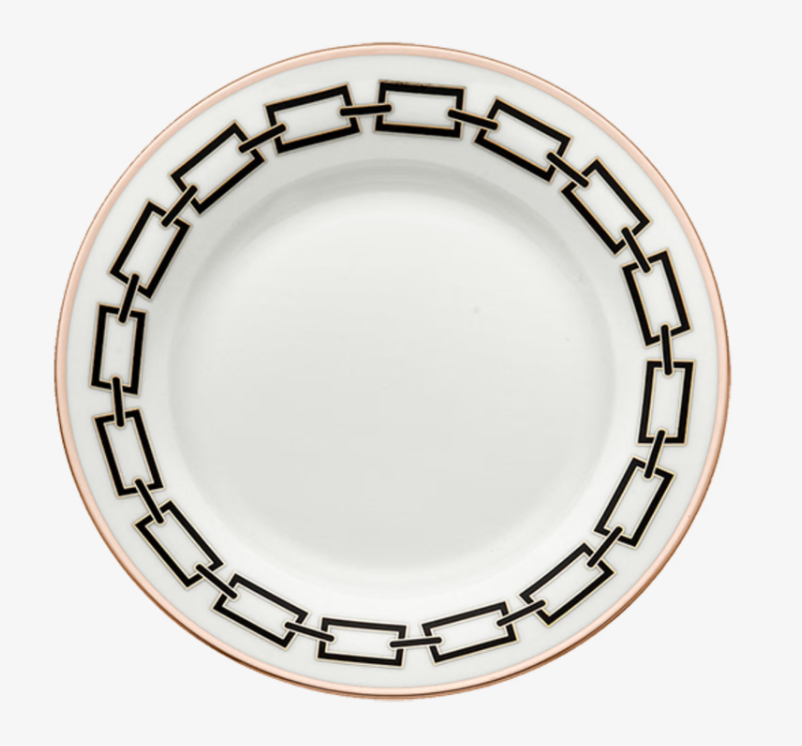 The Catene Nero Dinnerware by Ginori 1735 features a white ceramic plate adorned with a bold black chain-link geometric border and finished with a delicate gold edge.